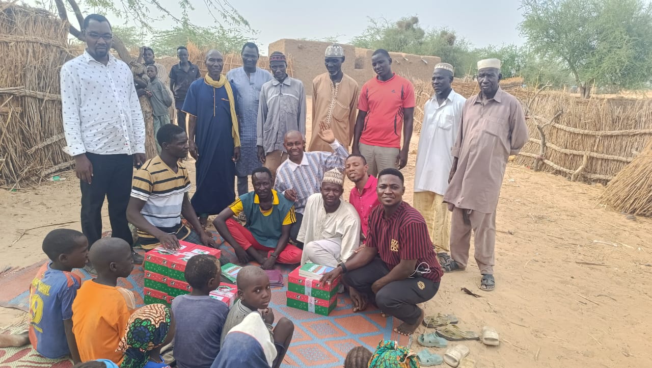 Distributing gift boxes to villagers during the mission in Niger